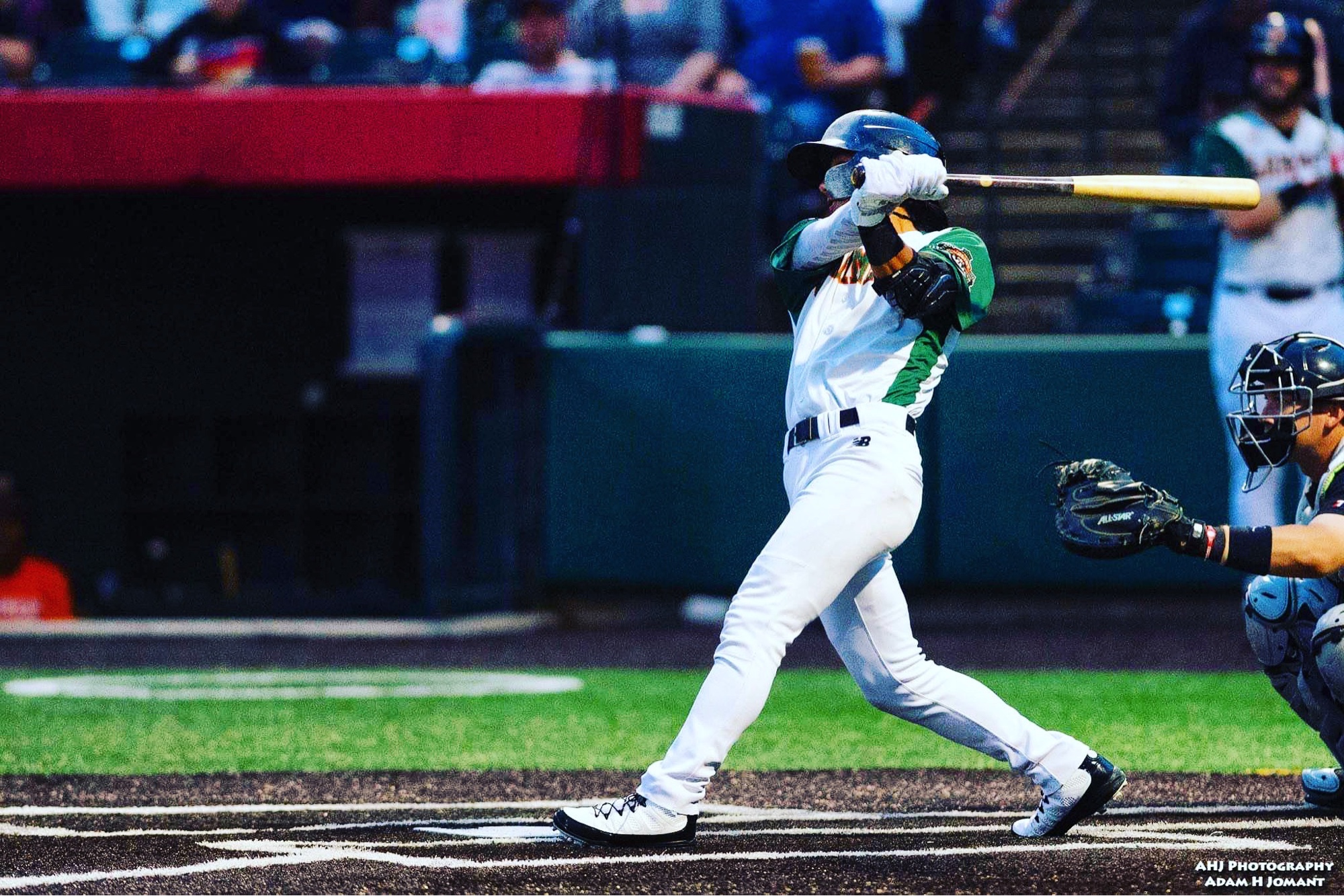 Chaz Meadows at the plate in a professional game, full swing follow-through